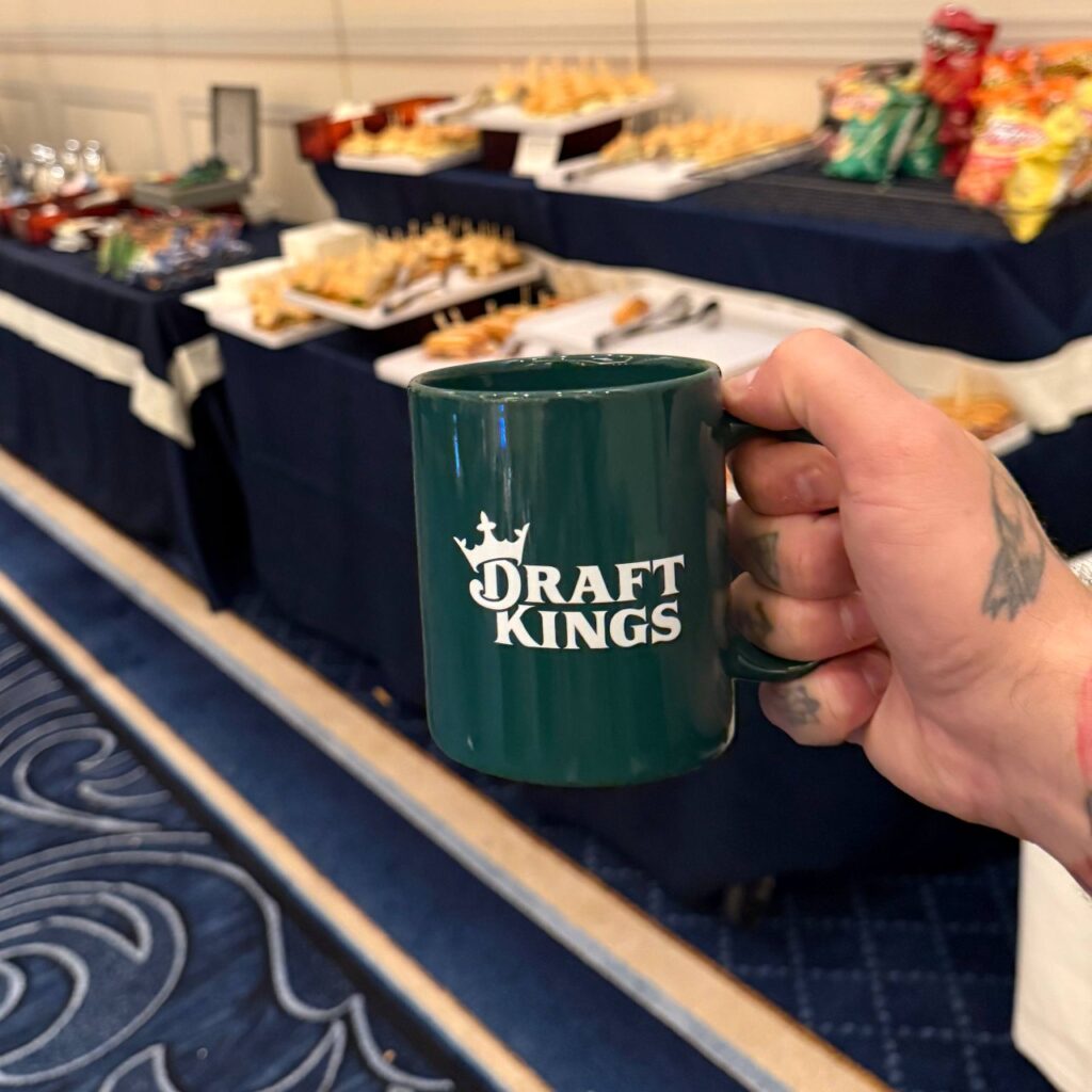 DraftKings press lounge at G2E 2025 Las Vegas, branded coffee mug and media catering at The Venetian Expo